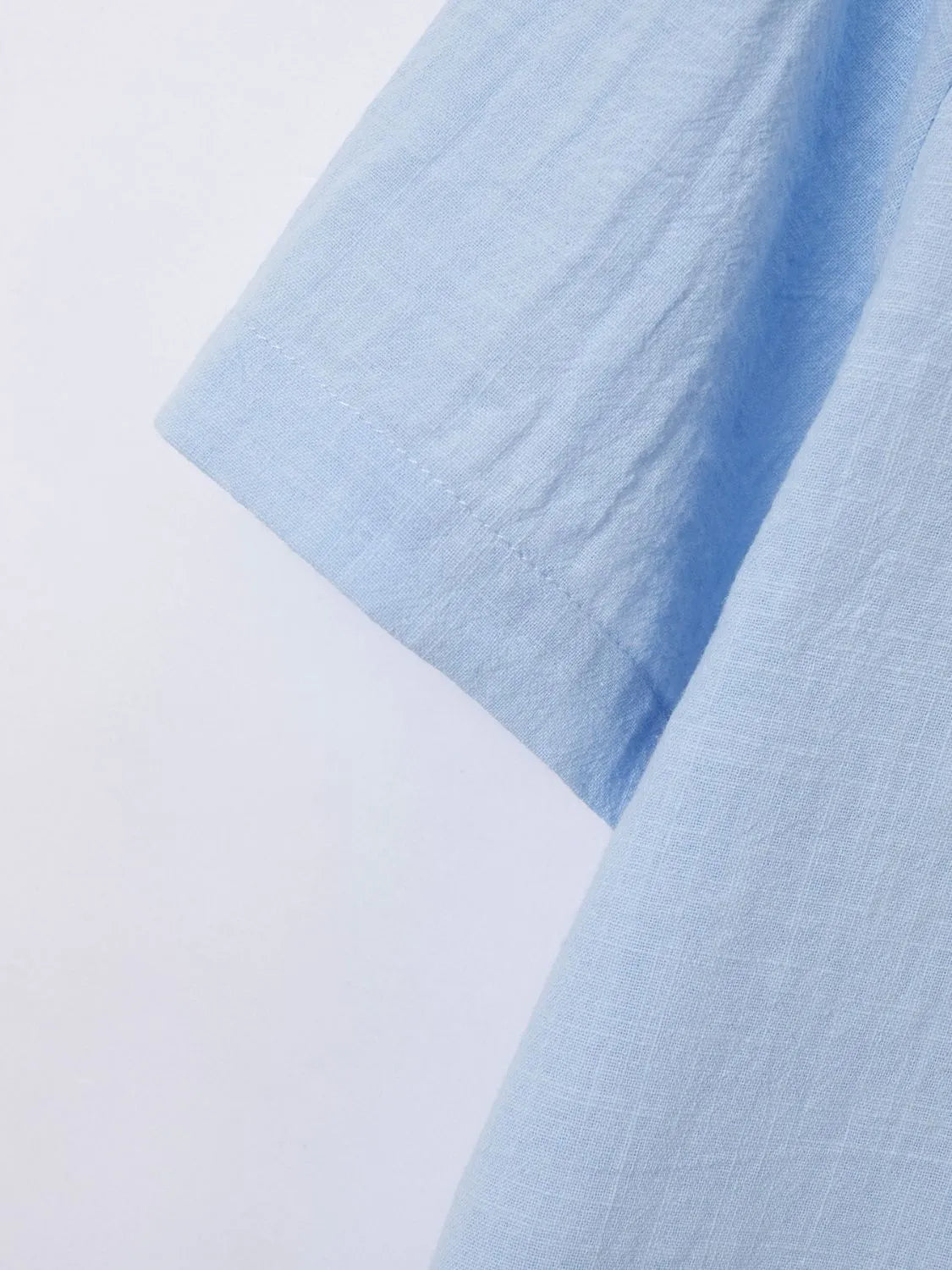 Light blue linen polo shirt sleeve detail