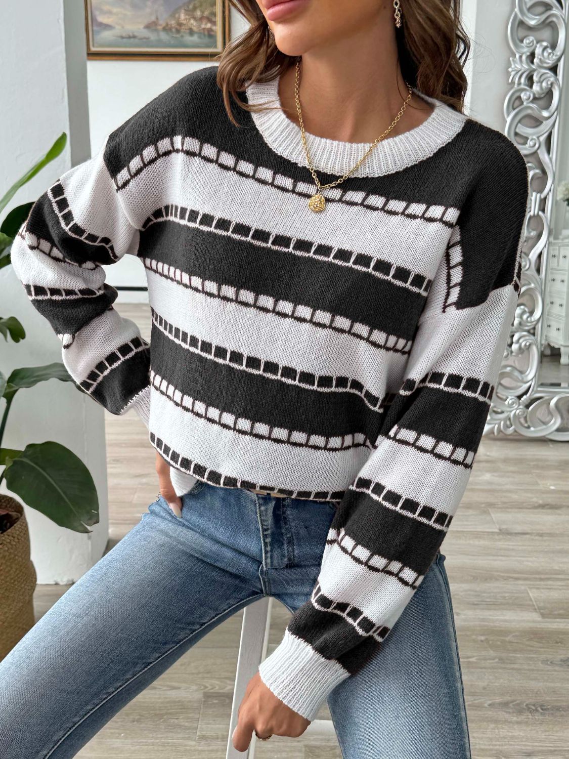 Textured stripe crewneck sweater in black and white with a ribbed neckline and cuffs.