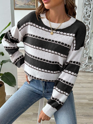 Textured stripe crewneck sweater in black and white with a ribbed neckline and cuffs.
