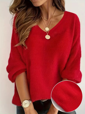Red V-neck knit sweater with 3/4 sleeves, textured fabric, and a relaxed fit.