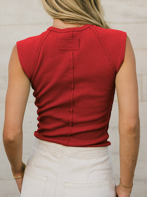 Red ribbed tank top with structured shoulders and a center back seam detail.