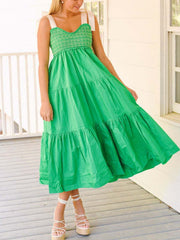Green tie shoulder tiered midi dress with smocked bodice and white ribbon straps.