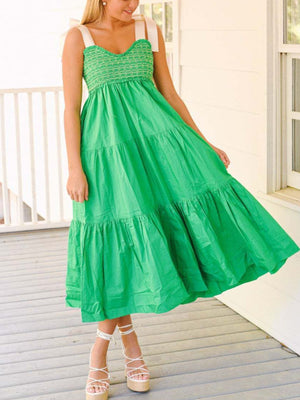 Green tie shoulder tiered midi dress with smocked bodice and white ribbon straps.