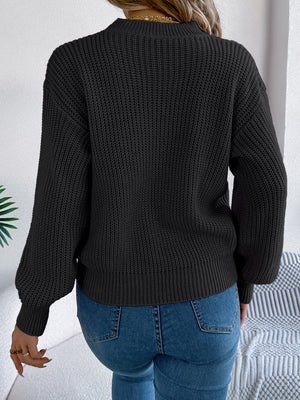 Black acrylic knit sweater with ribbed details and balloon sleeves.
