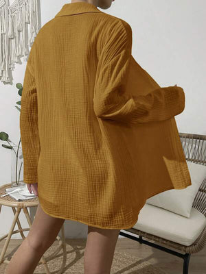 Textured gauze shirt in mustard yellow, featuring a relaxed fit and buttoned front, styled casually.
