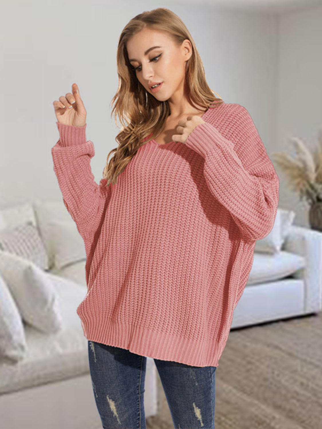 Relaxed fit dusty pink ribbed knit sweater with V-neck and batwing sleeves.