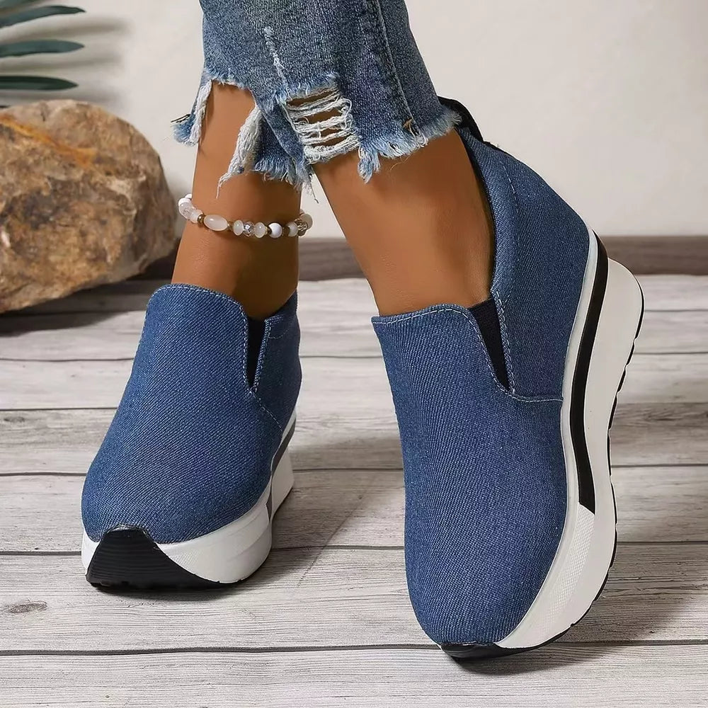 Blue denim slip-on shoes with round toe and chunky platform sole.