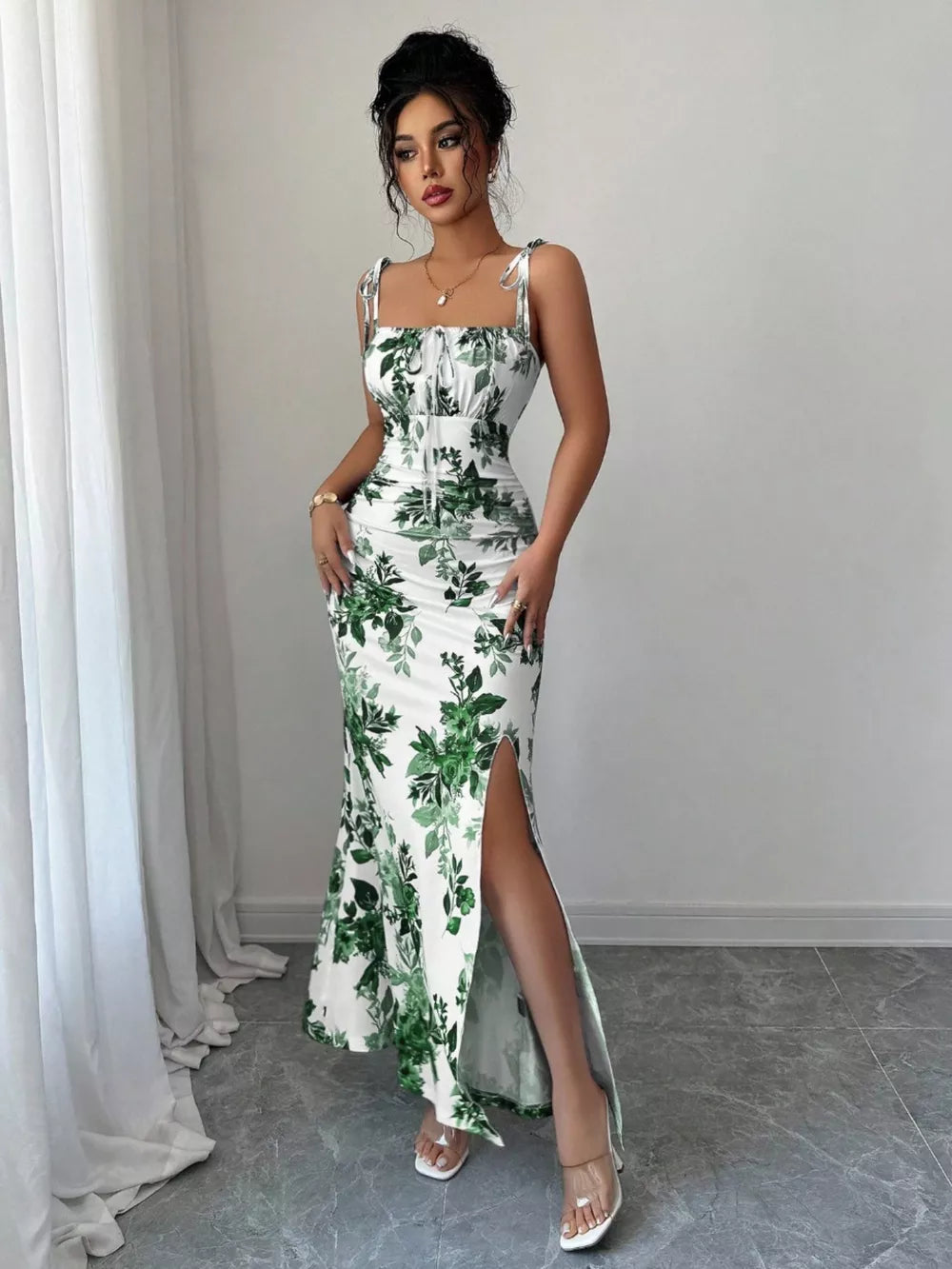 Maxi dress with floral print, tie straps, ruched bodice, and high slit.