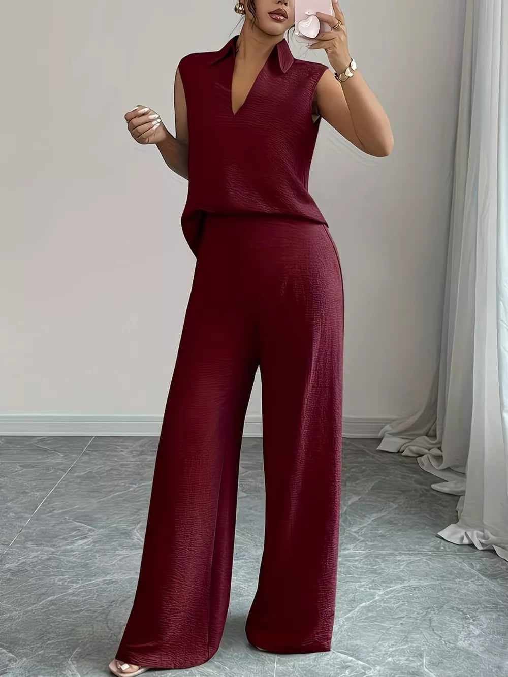 Burgundy sleeveless collared top and wide-leg pants set with textured fabric.