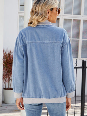 Relaxed medium wash denim bomber jacket with grey ribbed collar, cuffs, and hem.
