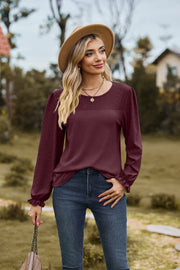 Burgundy waffle knit blouse with eyelet detail and ruffled cuffs