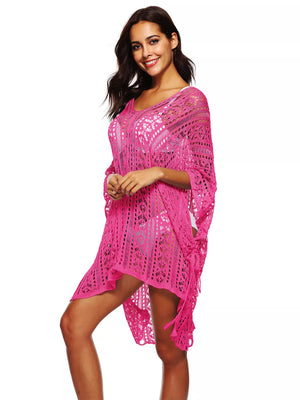 Fuchsia pink crochet V-neck beach cover-up with cutout details and fringe.