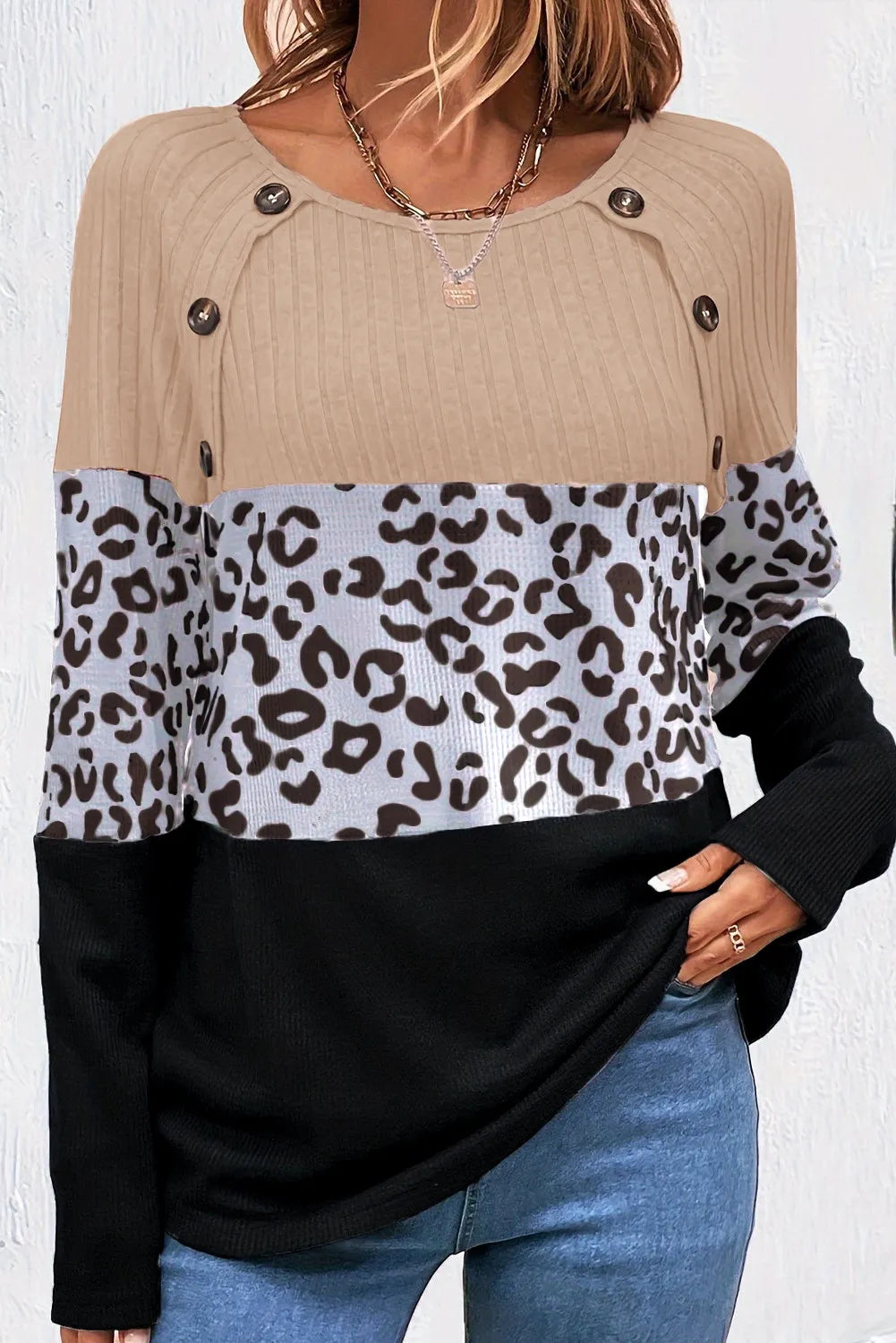 Colorblock leopard print ribbed knit top with button detail and long sleeves.