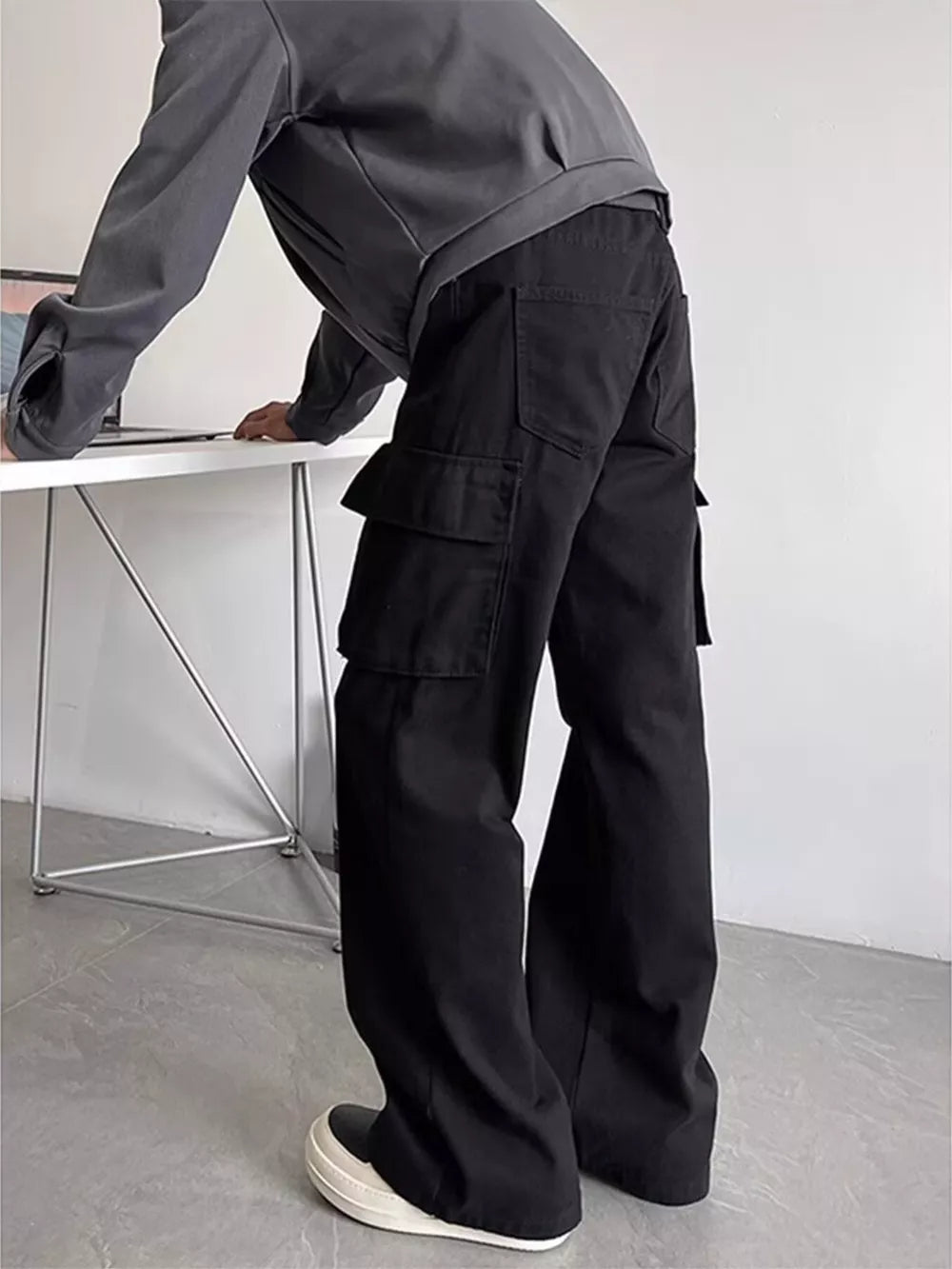 Black cargo pants with multiple pockets and a relaxed fit.