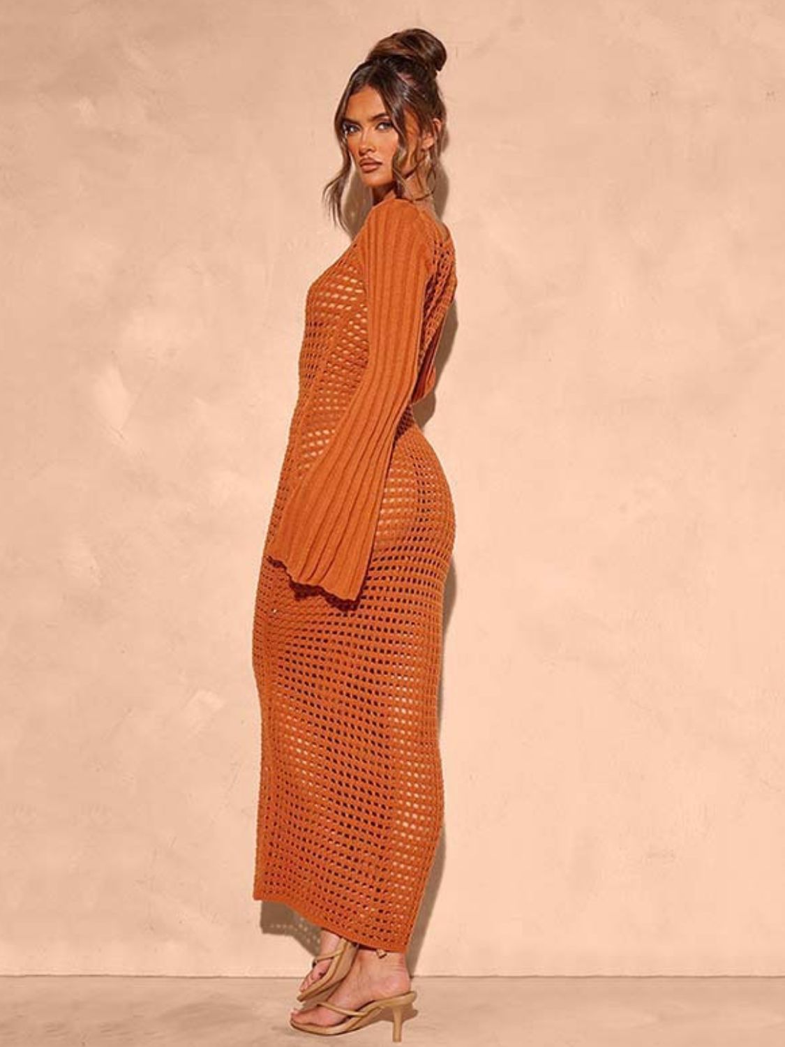Terracotta open knit maxi dress with bell sleeves and a crochet pattern.