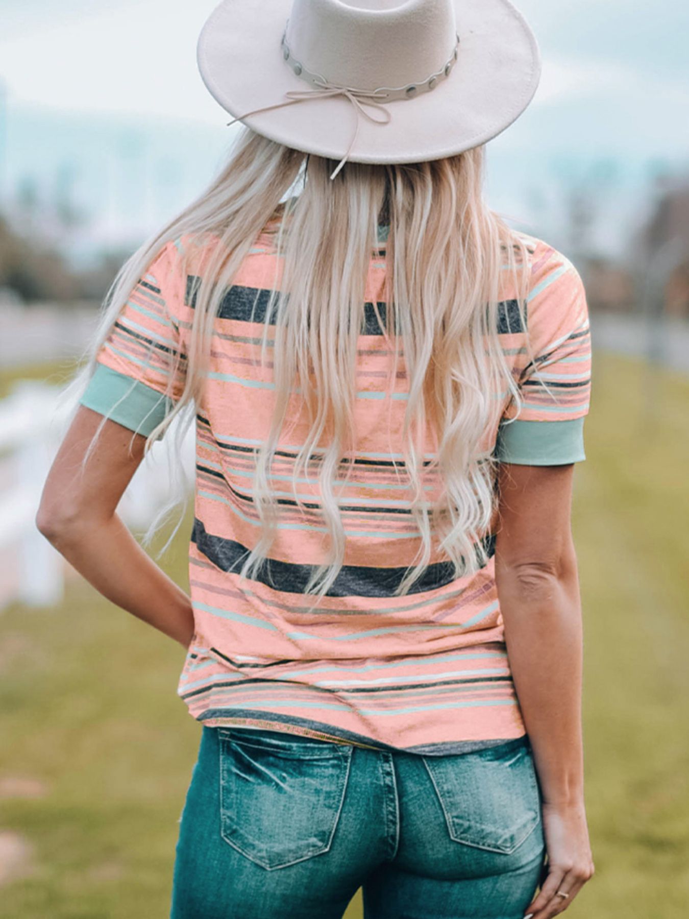 Striped crew neck t-shirt in dusty pink with teal cuffs.
