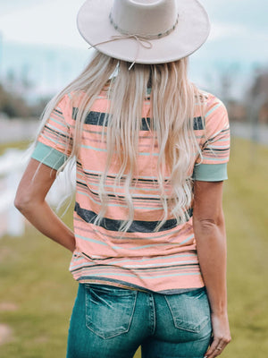 Striped crew neck t-shirt in dusty pink with teal cuffs.