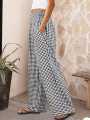 Maternity pants in black plaid gingham with a smocked waistband and wide legs.