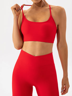 Red ribbed halterneck active bra with thin straps and a scoop neckline.