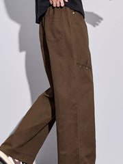 Brown loose-fit men's sweatpants with drawstring and side pocket detail.