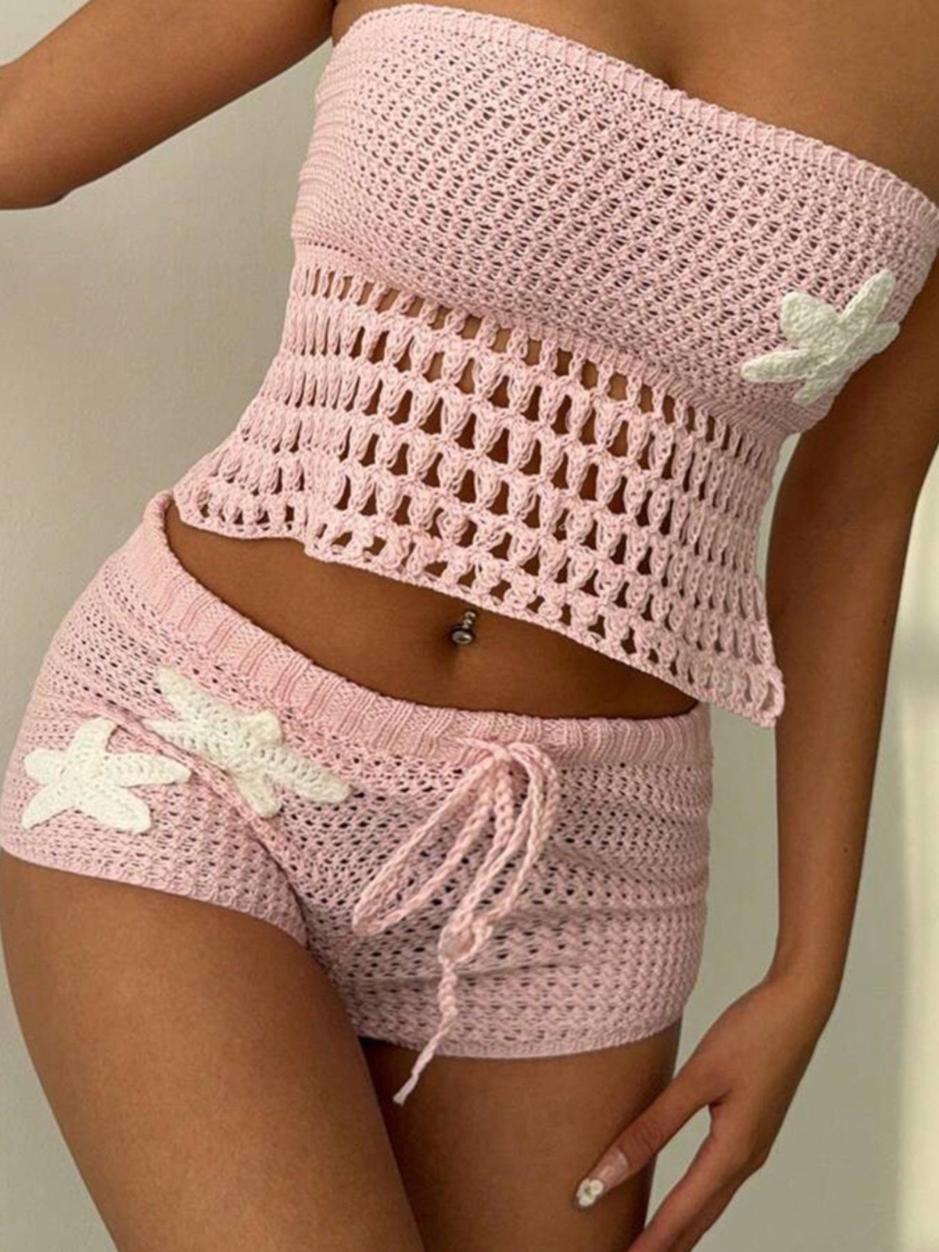 Pink crochet tube top and shorts set with white applique details and drawstring shorts.