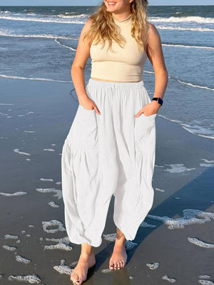 White linen balloon trousers with cargo pockets and elastic waist