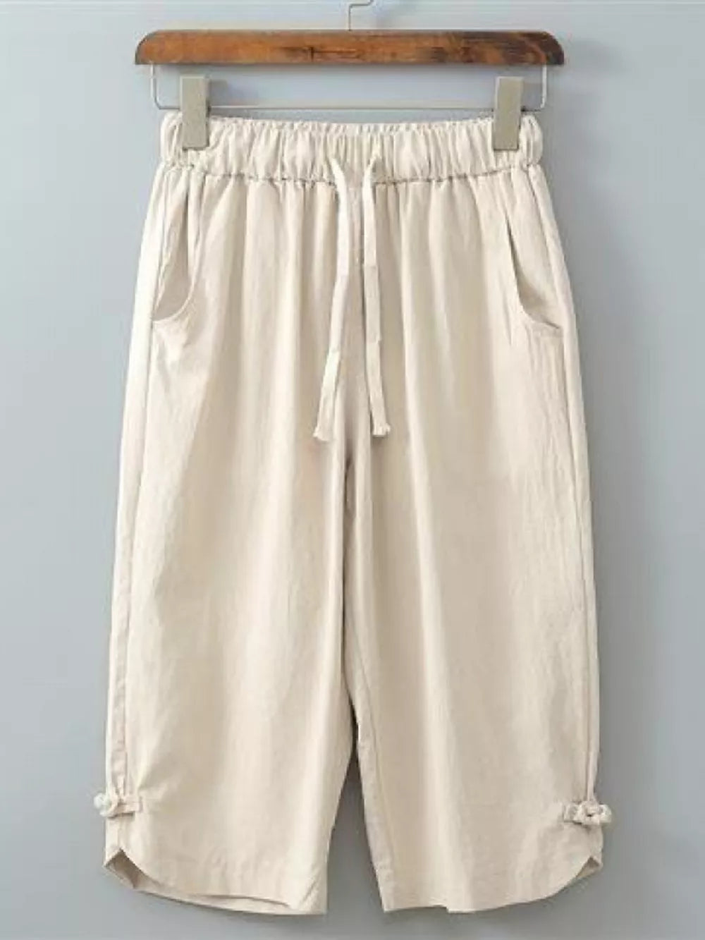 Khaki drawstring cropped sweatpants with tie details at the hem.