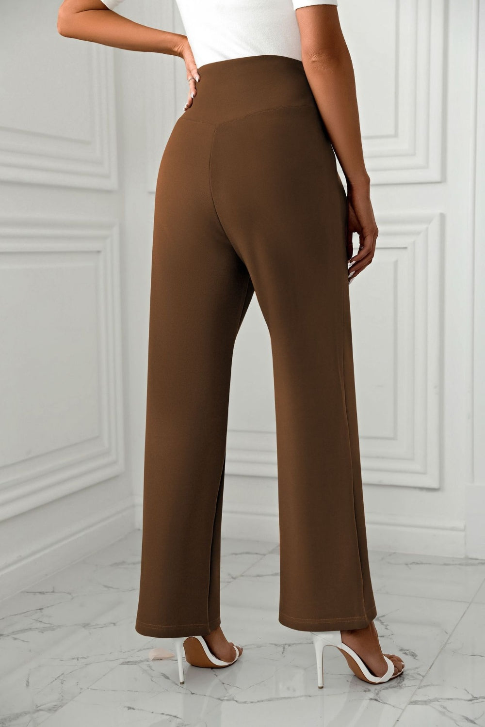 Brown wide-leg trousers with a sculpted waist, shown from the back.