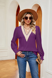 Purple V-neck blouse with lace sleeves and smocked cuffs.