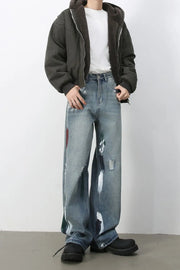 Ink-Blot Wide Leg Denim jeans in medium wash with abstract paint splatters and distressed details.