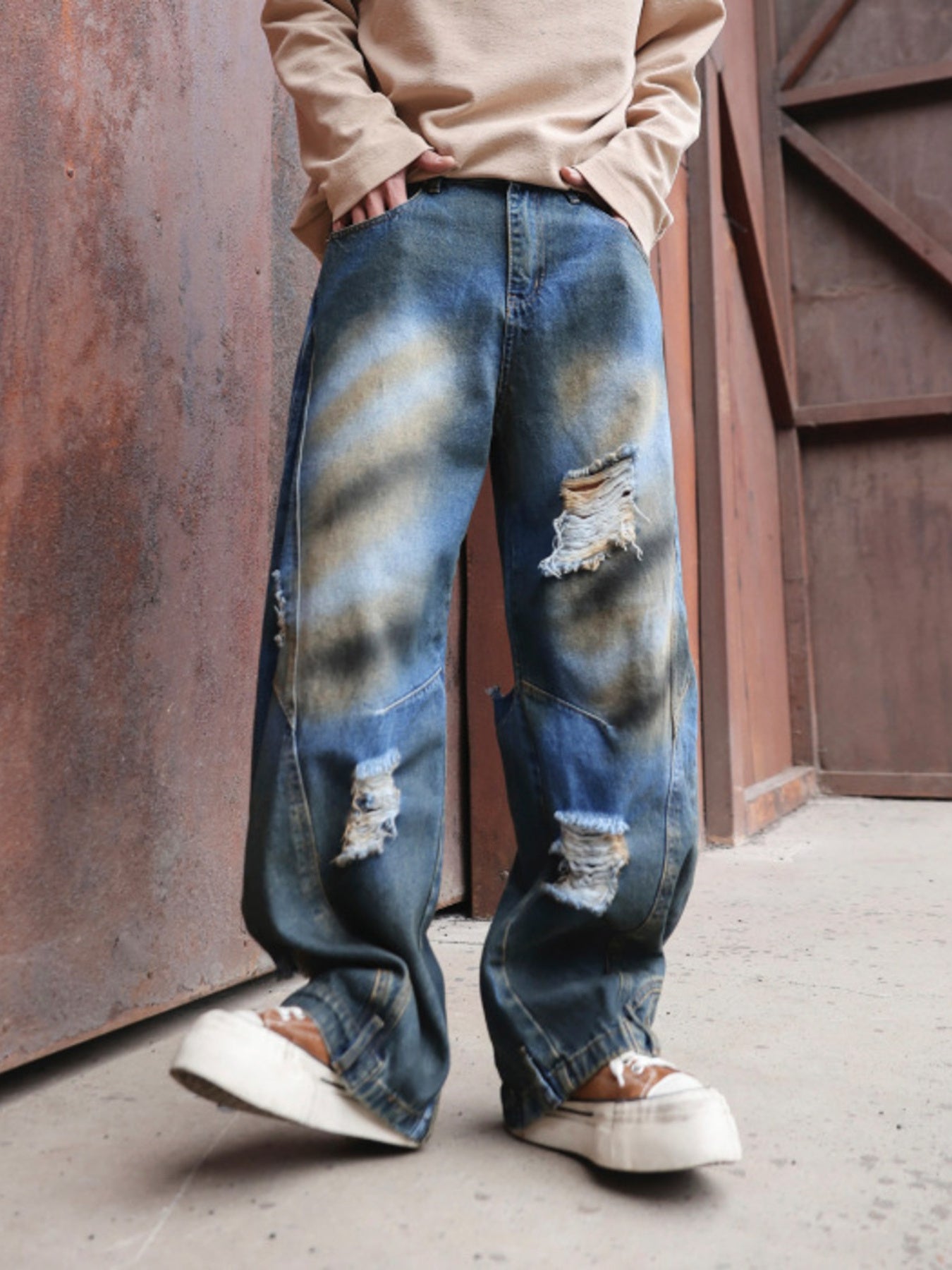 Men's distressed wide-leg jeans in dark wash denim with ripped details.