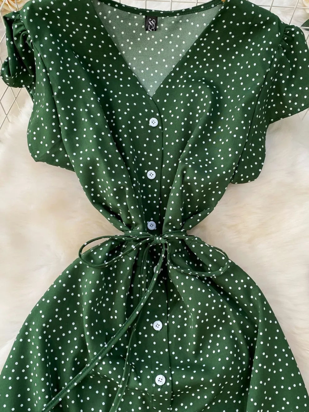 Green polka dot maxi dress with belt, V-neck, button front, short sleeves.
