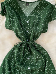 Green polka dot maxi dress with belt, V-neck, button front, short sleeves.