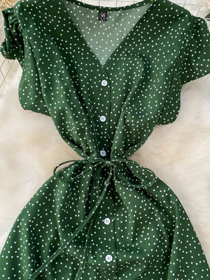Green polka dot maxi dress with belt, V-neck, button front, short sleeves.
