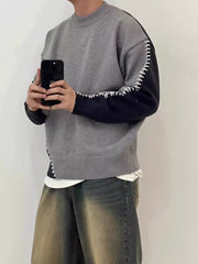 Men's gray and black two-tone knit sweater with contrast stitching detail.