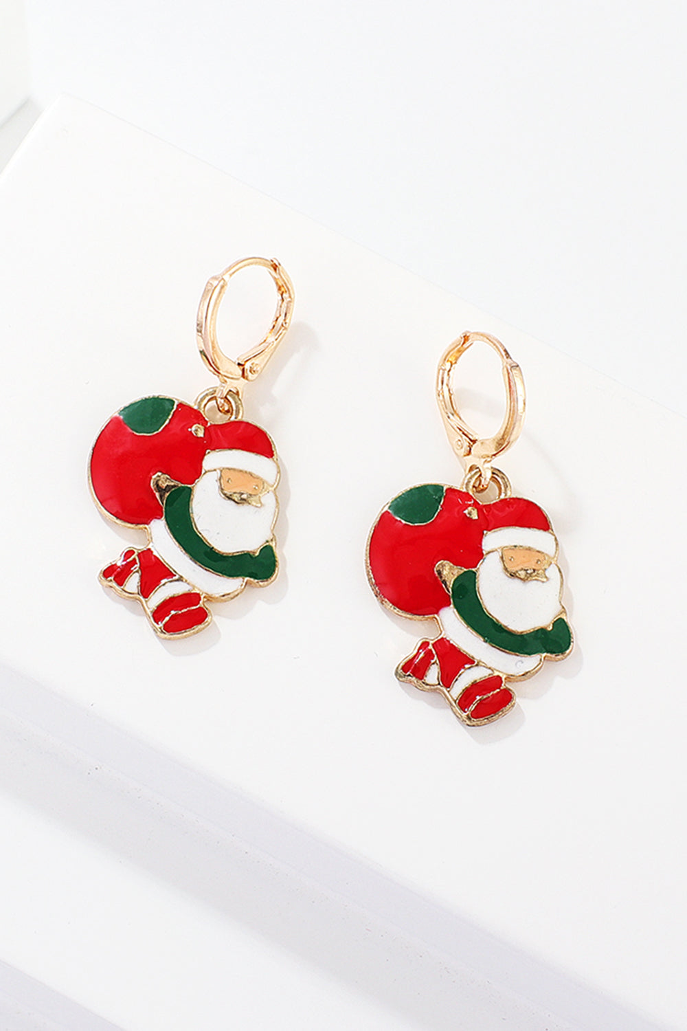 Festive Santa charm hoop earrings in red, green, and white enamel with gold-tone alloy.