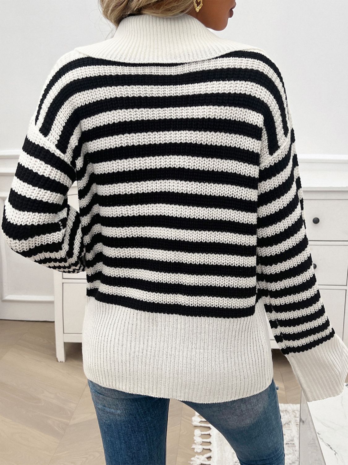 Black and white stripe knit pullover sweater with wide collar and ribbed cuffs.