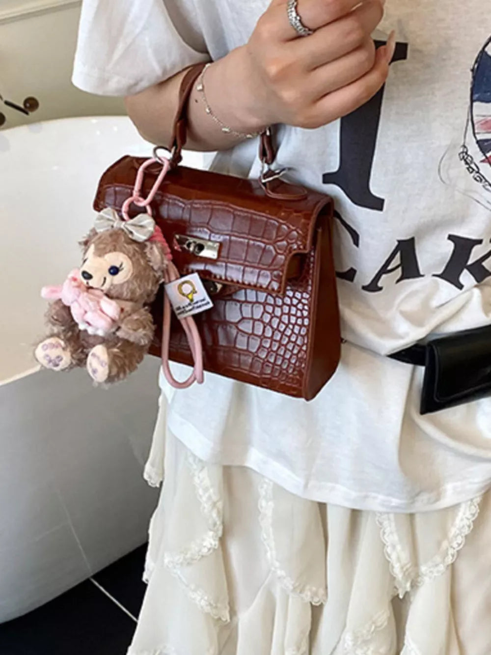 Crocodile-embossed Medium Handbag in Brown, side view
