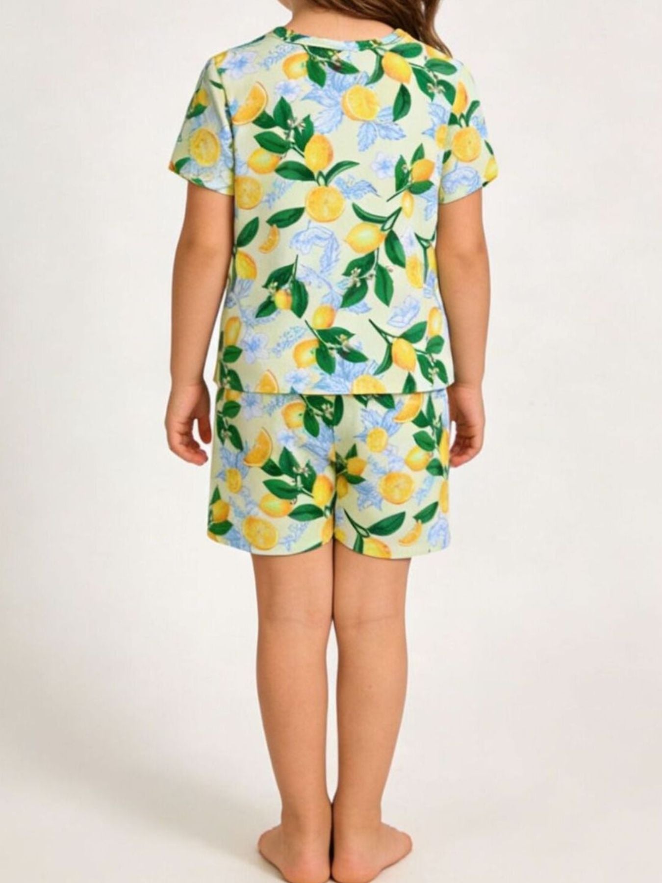 Toddler lemon print outfit set with short sleeves and shorts in light yellow.