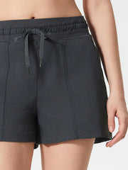 Dark gray utility shorts with drawstring waist and seamed pockets.