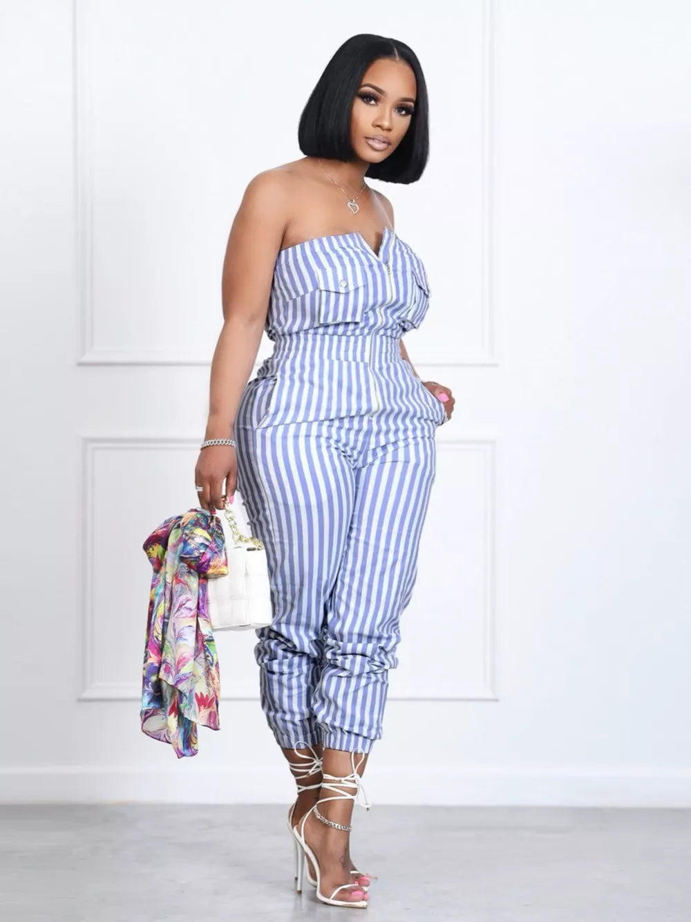 Blue striped strapless romper with pockets and cinched ankles.