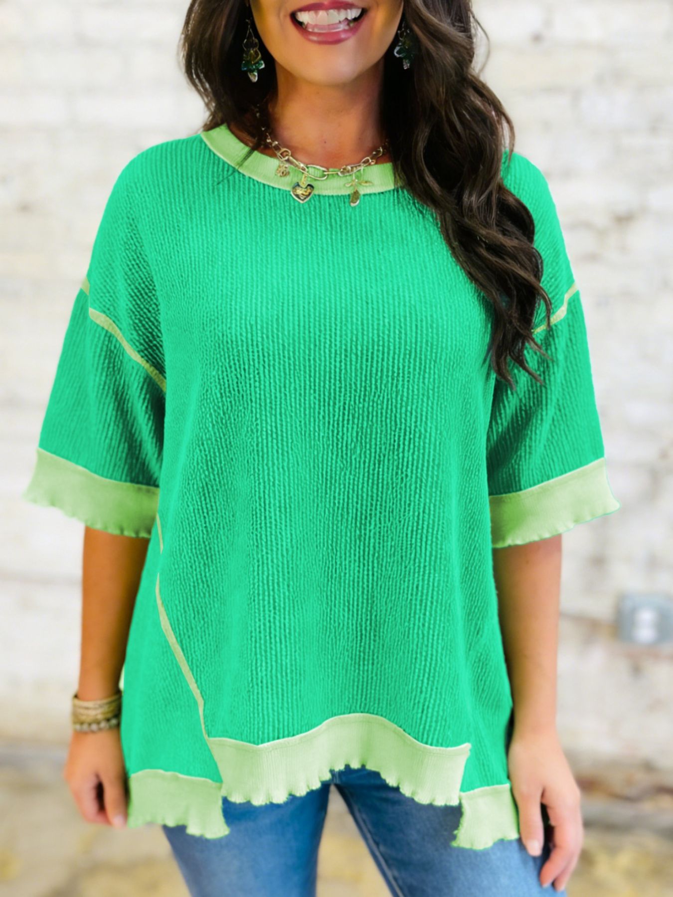 Bright green ribbed t-shirt with contrast trim and asymmetrical hem