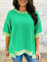 Bright green ribbed t-shirt with contrast trim and asymmetrical hem