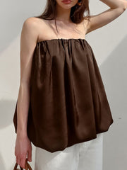 Dark brown strapless bubble hem top with gathered neckline and voluminous silhouette.