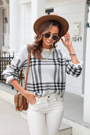 Checked plaid crewneck sweater in light gray acrylic with black pattern.