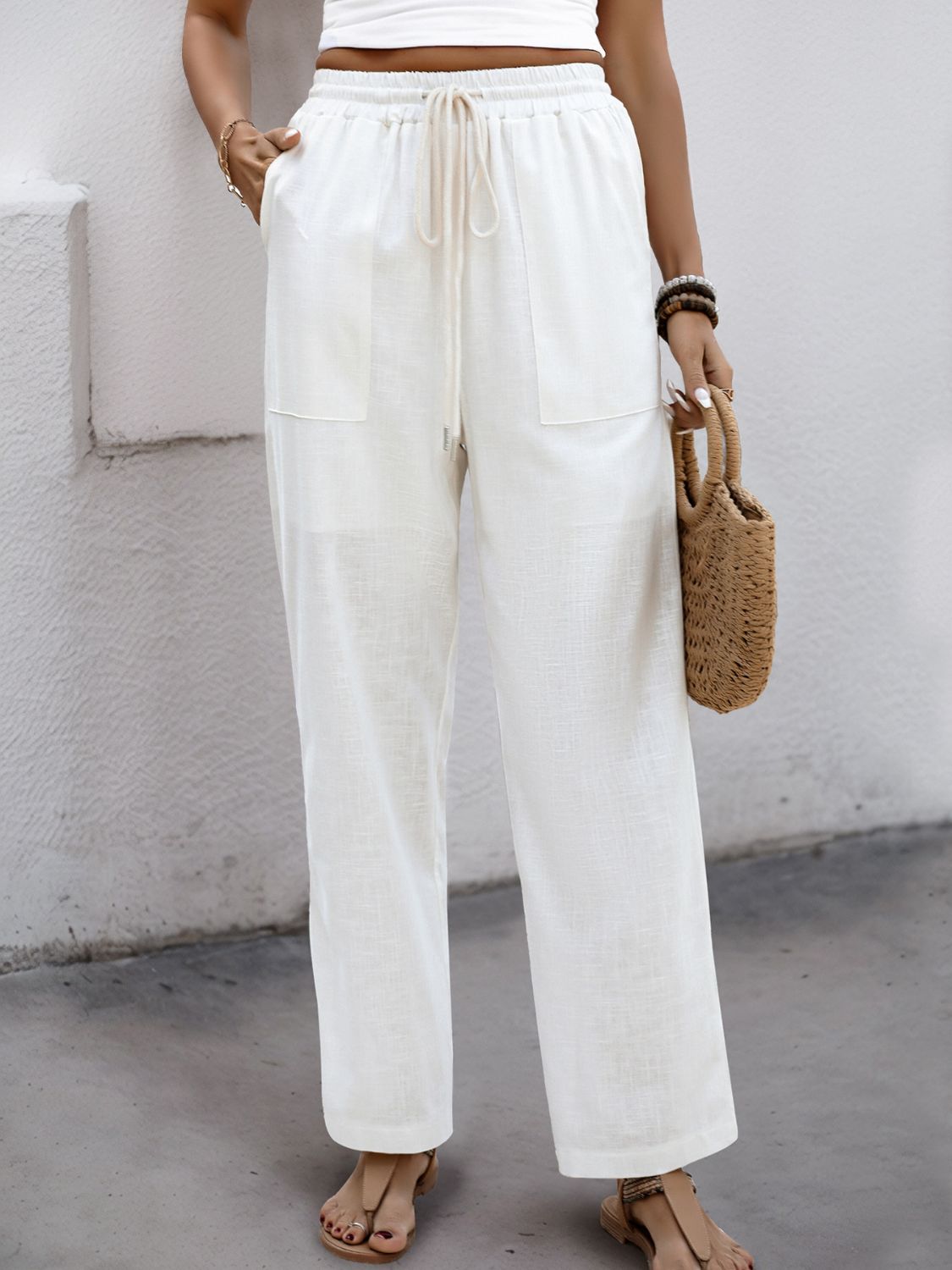 White linen-blend wide-leg trousers with drawstring waist and pockets