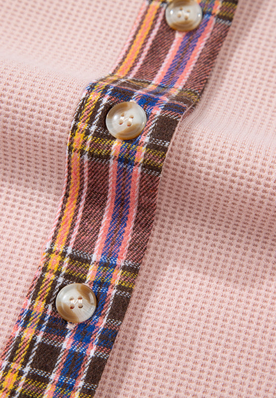 Blush pink waffle knit shacket with plaid trim and button detail.