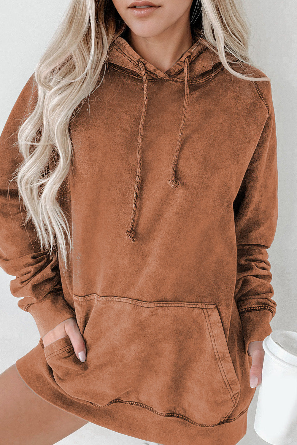 Textured raglan sleeve hoodie in a warm brown hue with a front pocket and drawstring hood.