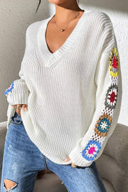 White knit sweater with colorful granny square sleeves and V-neck