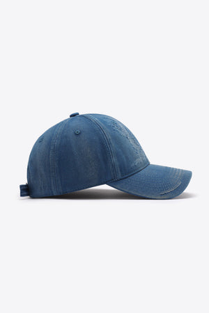 Baseball cap in distressed denim blue with adjustable strap and embroidered detail.